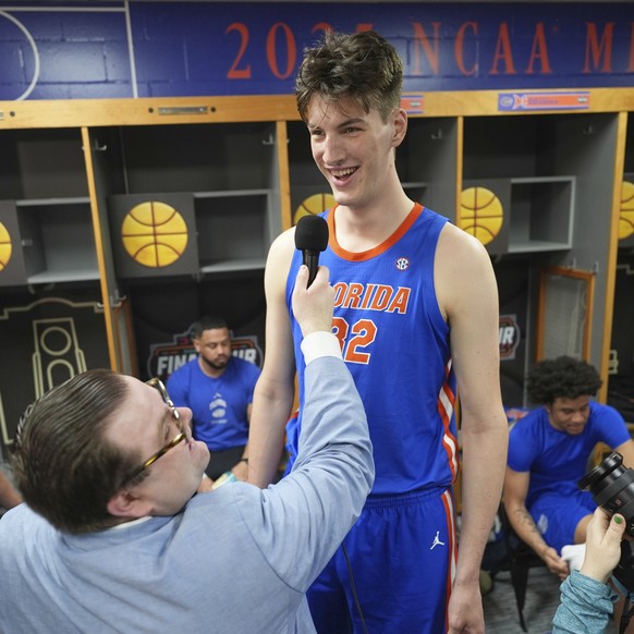Florida's Olivier Rioux (32) is interviewed in the locker room during media day at the Final Four of the NCAA college basketball tournament, Thursday, April 3, 2025, in San Antonio. (AP Photo/Eri ...