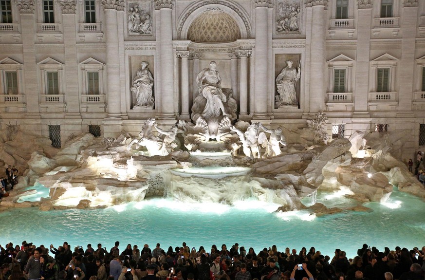 epa05009481 People gather in front of the landmark Trevi Fountain after its restoration in Rome, Italy, 03 November 2015 evening. The Trevi Fountain, one of Rome&#039;s most spectacular monuments and  ...