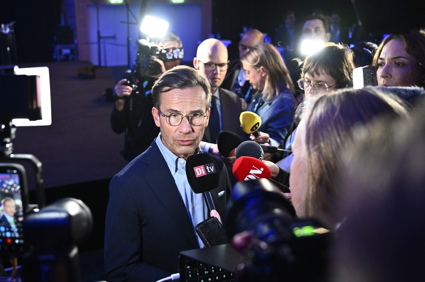 epa13238040 Moderates party leader Ulf Kristersson (C) speaks to the media during the Moderates' election night watch party in Stockholm, Sweden, 13 September 2026. Sweden's general election ...