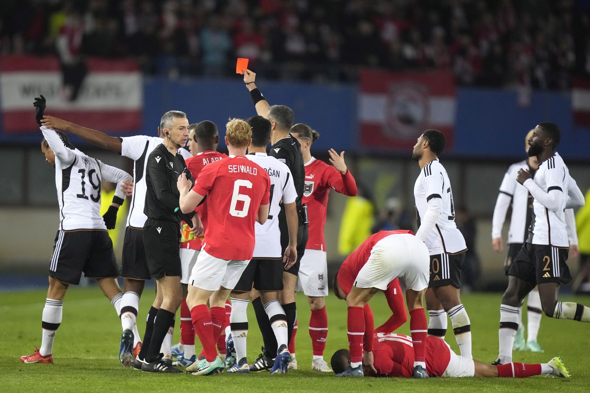 Germany's Leroy Sane, left, receives a red card and is sent off the pitch during the international friendly soccer match between Austria and Germany at the Ernst Happel stadium in Vienna, Austria ...
