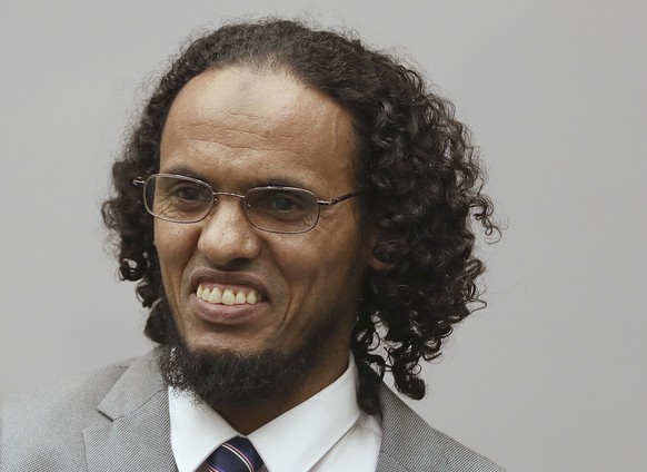 Ahmad Al Faqi Al Mahdi, right, a Malian Islamic extremist who pleaded guilty to destruction of historic mausoleums in Timbuktu, enters the court room to hear the verdict of the International Criminal  ...