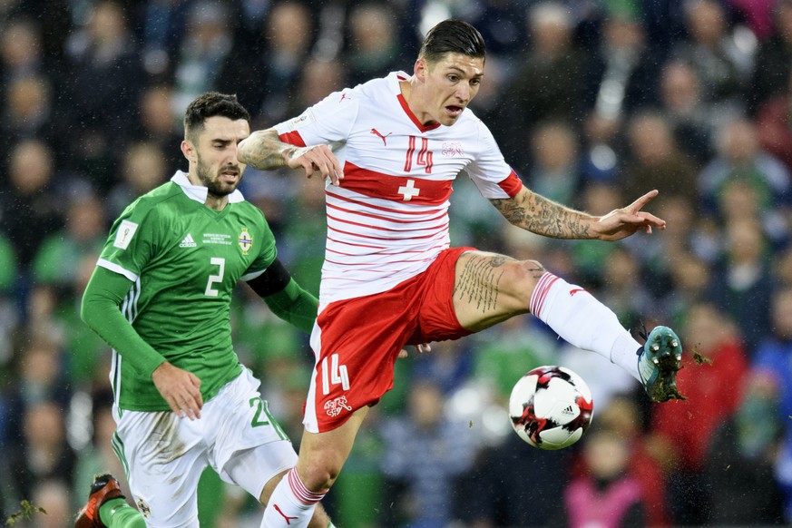 Northern Ireland's defender Conor McLaughlin, left, fights for the ball with Switzerland's midfielder Steven Zuber, right, during the 2018 Fifa World Cup play-offs first leg soccer match Northern Irel ...
