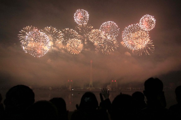 North Koreans gather to watch a New Year&#039;s fireworks display at the Kim Il Sung Square in Pyongyang, North Korea, on Sunday, Jan. 1, 2017. (AP Photo/Kim Kwang Hyon)