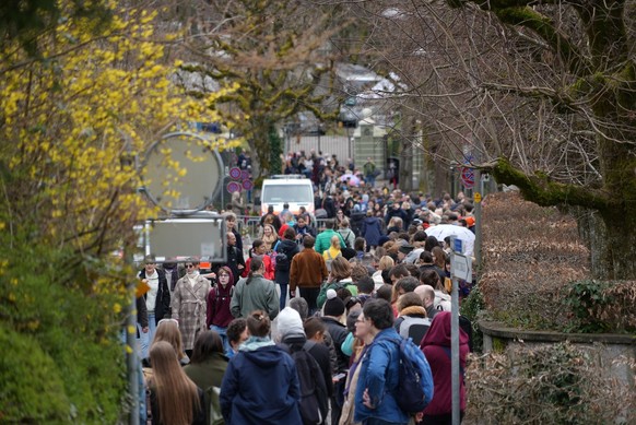 Russians living in Switzerland gather in front of the Russian embassy in Bern to take their vote during the Russian presidential elections and simultaneously protest against President Putin, on Sunday ...