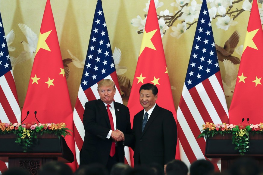 U.S. President Donald Trump, left, poses with Chinese President Xi Jinping for a photo after a joint press conference at the Great Hall of the People in Beijing, Thursday, Nov. 9, 2017. Trump is on a  ...