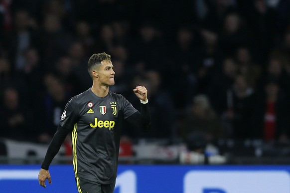 Juventus forward Cristiano Ronaldo celebrates after scoring his side&#039;s opening goal during the Champions League quarterfinal, first leg, soccer match between Ajax and Juventus at the Johan Cruyff ...