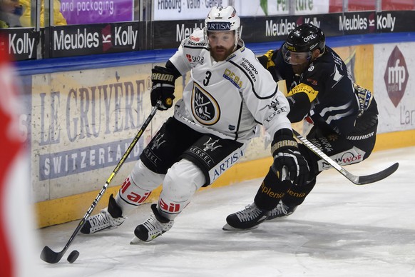 Luganos Julien Vauclair, links, und Gotterons Tristan Vauclair, rechts, kaempfen um den Puck, beim Eishockey Meisterschaftsspiel der National League A zwischen den HC Fribourg Gotteron und dem HC Luga ...