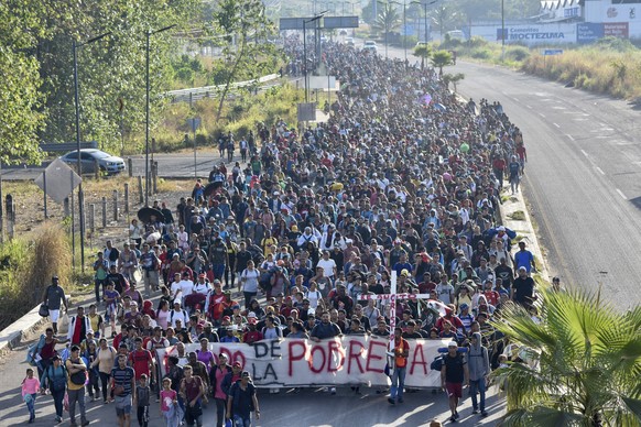 FILE - Migrants depart from Tapachula, Mexico, Dec. 24, 2023. Former President Donald Trump is seizing on his party&#039;s frustration with the recent surge of illegal crossings at the southern U.S. b ...