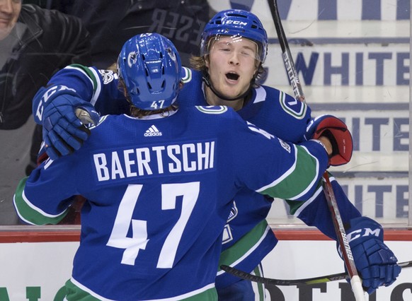 Vancouver Canucks&#039; Brock Boeser, back, celebrates his goal against the Vegas Golden Knights with Sven Baertschi, of Switzerland, during the second period of an NHL hockey game Thursday, Nov. 16,  ...