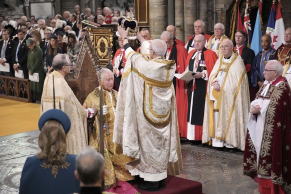 King Charles III sits as he receives The St Edward&#039;s Crown during the coronation ceremony at Westminster Abbey, London, Saturday, May 6, 2023. (Jonathan Brady/Pool Photo via AP)