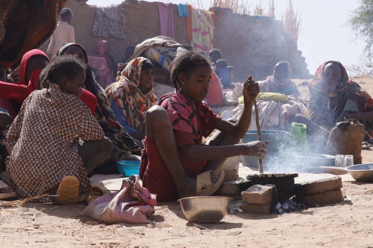 250711 -- EL FASHER SUDAN, July 11, 2025 -- A girl prepares food at a displacement camp in El Fasher, North Darfur region, Sudan, on July 9, 2025. The United Nations Children s Fund said Friday that t ...
