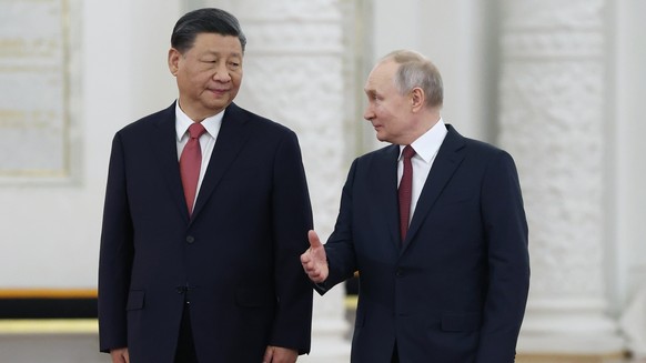 FILE - Russian President Vladimir Putin, right, speaks to Chinese President Xi Jinping as they attend an official welcome ceremony at The Grand Kremlin Palace, in Moscow, Russia, March 21, 2023. Chine ...