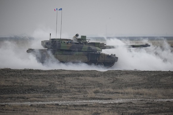 A French Leclerc main battle tank is engulfed by smoke during an exercise at a training range in Smardan, eastern Romania, Wednesday, Jan. 25, 2023. Around 600 French soldiers deployed to Romania as p ...