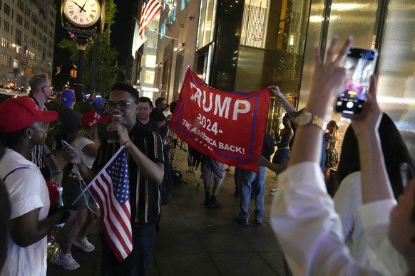Supports for Republican presidential candidate former President Donald Trump gather outside Trump Tower in New York, Saturday, July 13, 2024, after Trump was injured during a shooting at a campaign ra ...