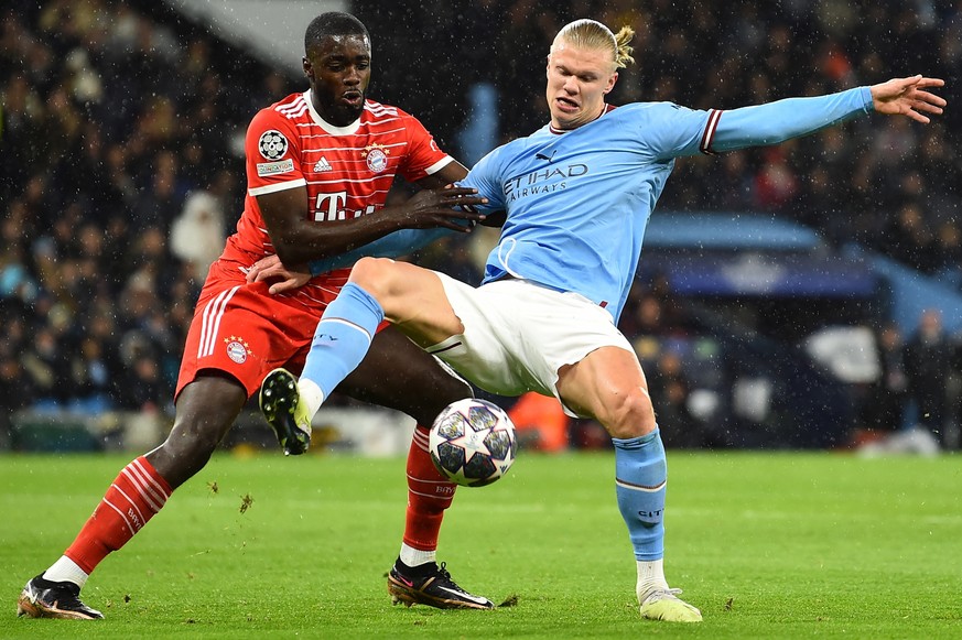 epa10568800 Erling Haaland of Manchester City (R) in action against Dayot Upamecano of Bayern Muncih (L) during the UEFA Champions League quarter final 1st leg match between Manchester City and Bayern ...