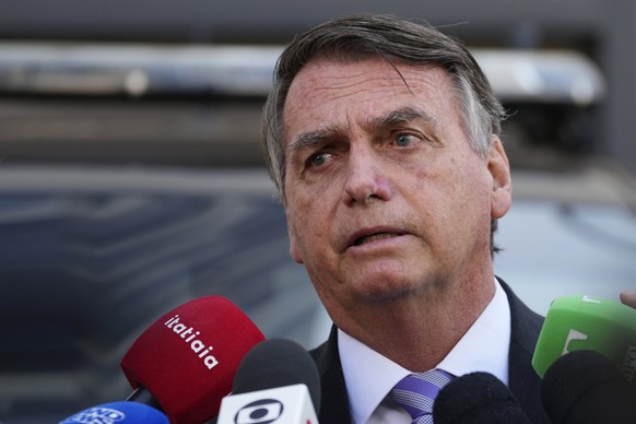 Brazil's former president Jair Bolsonaro speaks to the press as he leaves the Federal Police headquarters where he gave testimony about his actions in connection with the January 8 attacks on government buildings.