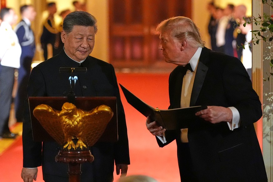 President Donald Trump talks with China's President Xi Jinping during a State Dinner in the East Room of the White House, Thursday, Sept. 24, 2026, in Washington. (AP Photo/Alex Brandon)
Donald T ...