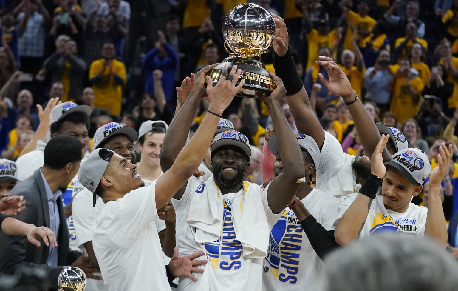 Golden State Warriors celebrate with the conference trophy after defeating the Dallas Mavericks in Game 5 of the NBA basketball playoffs Western Conference finals in San Francisco, Thursday, May 26, 2 ...