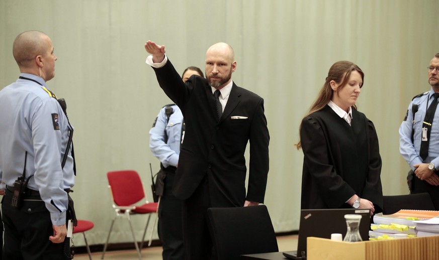 epa05709038 Anders Behring Breivik (C) raises his right arm at the appeal case in Borgarting Court of Appeal at Telemark prison in Skien, Norway, 10 January 2017. The Norwegian Ministry of Justice and ...