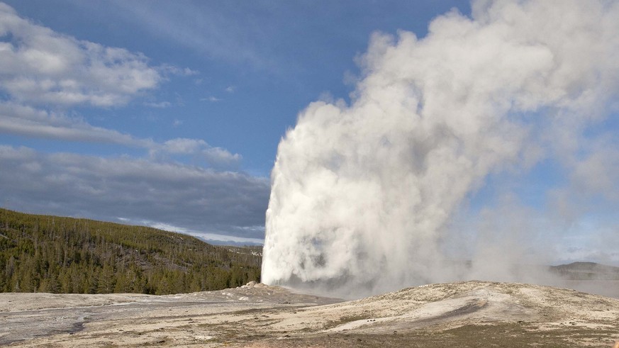 FILE - In this May 21, 2011 file photo, tourists photograph Old Faithful erupting, at Yellowstone National Park, in Mont. Old Faithful is among the park’s hydrothermal features powered by the Yellowst ...