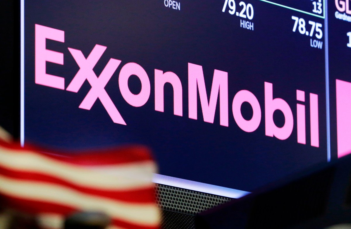 FILE - In this April 23, 2018, file photo, the logo for ExxonMobil appears above a trading post on the floor of the New York Stock Exchange. Exxon Mobil shareholders have unseated a third board member ...