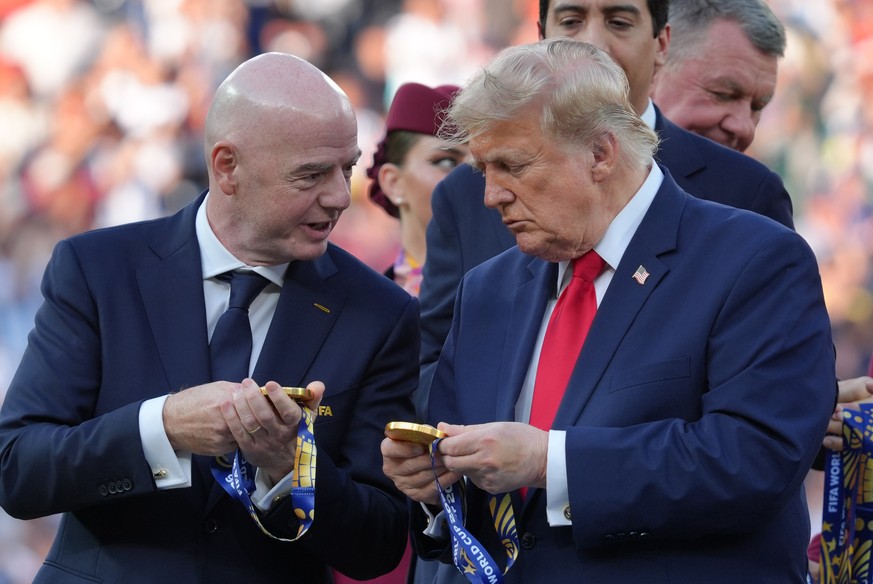 FIFA President Gianni Infantino, left, President Donald J. Trump comment on the medals as they wait to congratulate the Spanish players after the World Cup final soccer match between Spain and Argenti ...