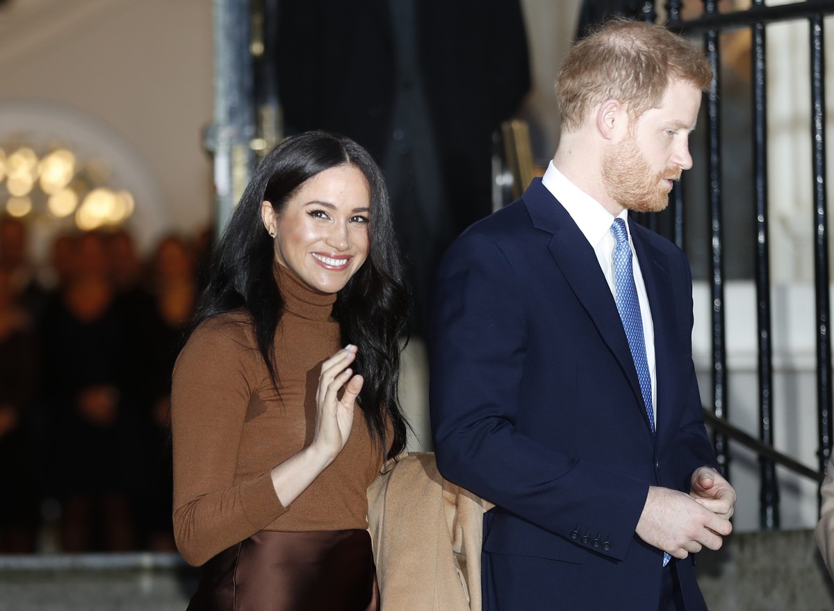 FILE - In this Tuesday, Jan. 7, 2020 file photo, Britain's Prince Harry and Meghan, Duchess of Sussex smile as they leave Canada House, in London. Prince Harry and his wife Meghan 'stepping  ...