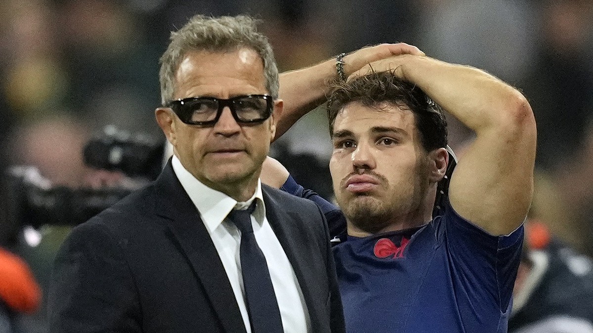 France's head coach Fabien Galthie, left, and Antoine Dupont react at the end of the Rugby World Cup quarterfinal match between France and South Africa at the Stade de France in Saint-Denis, near ...