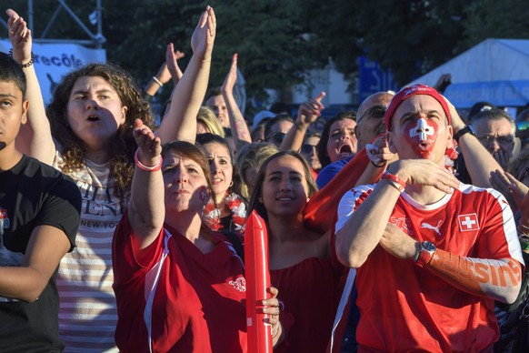 A Swiss supporter reacts during the public viewing of the FIFA 2018 World Cup Group E soccer match between Switzerland and Serbia, in the public viewing zone on Plainpalais, Geneva, Switzerland this F ...