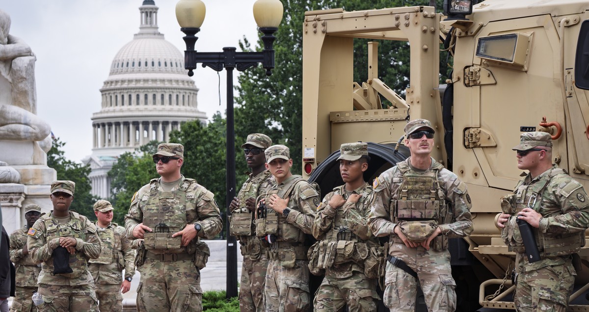 Protesters, police, and National Guard troops congregate at the entrance to Union Station in Washington, where Defense Secretary Pete Hegseth and Vice President JD Vance visited Wednesday, Aug. 20, 20 ...