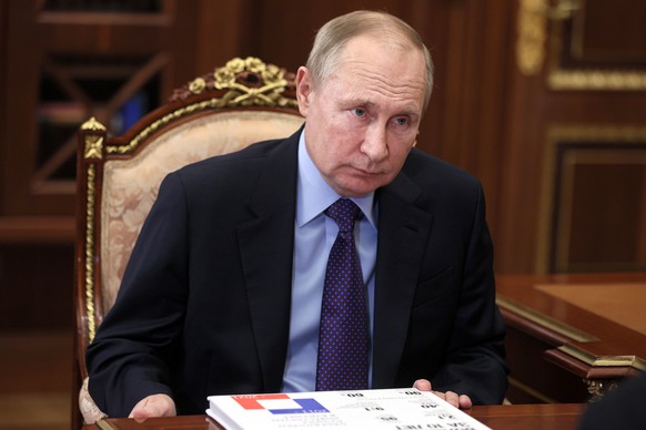 Russian President Vladimir Putin listens during a meeting in Moscow, Russia, Thursday, Dec. 30, 2021. (Alexei Nikolsky, Sputnik, Kremlin Pool Photo via AP)