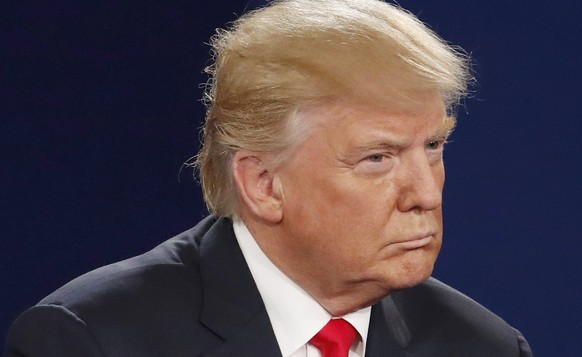 Republican U.S. presidential nominee Donald Trump listens during the second U.S. presidential town hall debate between Trump and Democratic U.S. presidential nominee Hillary Clinton at Washington Univ ...