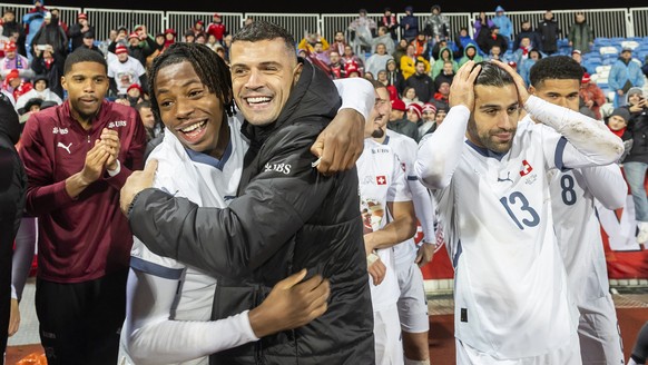 epa12534619 From left to right, Switzerland's Johan Manzambi, Switzerland's Granit Xhaka and Switzerland's Ricardo Rodriguez, celebrates with teammates the qualification for the FIFA 20 ...