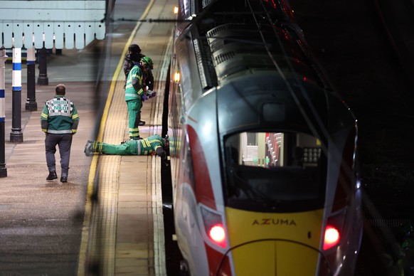 Emergency personnel inspect a train at the Huntingdon, England, train station in Cambridgeshire after people were stabbed Saturday, Nov. 1, 2025. (Chris Radburn/PA via AP)
Britain-Train-Stabbings