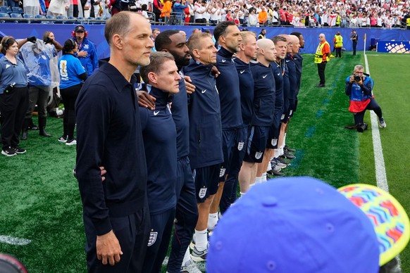 England head coach Thomas Tuchel listens to the national anthems with members of his staff during the World Cup Group L soccer match between England and Ghana in Foxborough, Mass., near Boston, Tuesda ...