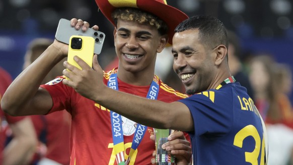 BERLIN, GERMANY - JULY 14: Lamine Yamal of Spain poses with his father Mounir Nasraoui following the UEFA EURO 2024 final match between Spain and England at Olympiastadion on July 14, 2024 in Berlin,  ...
