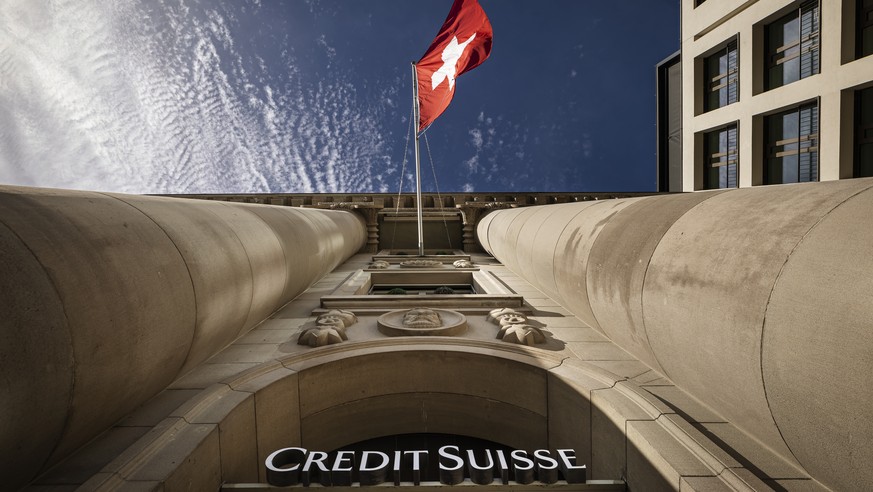 The logo of Swiss bank Credit Suisse is seen beside a Swiss flag on a building in Lucerne, Switzerland, on March 16, 2023. Credit Suisse, which was beset by problems long before the U.S. bank failures ...