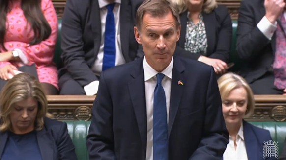 epa10249029 A grab from a handout video made available by the UK Parliamentary Recording Unit shows Britain&#039;s Chanceller of the Exchequer, Jeremy Hunt (C) delivering a statement in the House of C ...