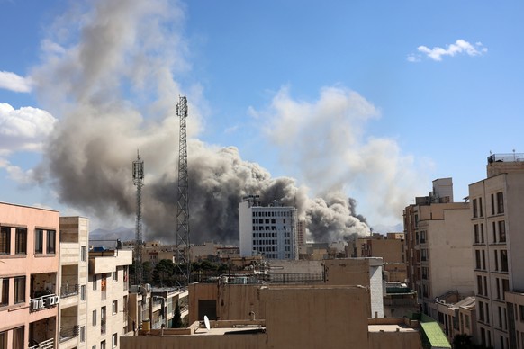 epa12786534 Smoke rises in central Tehran after an Israeli attack in Iran, 01 March 2026. A joint Israeli and US military operation continues on its second day after targeting multiple locations acros ...