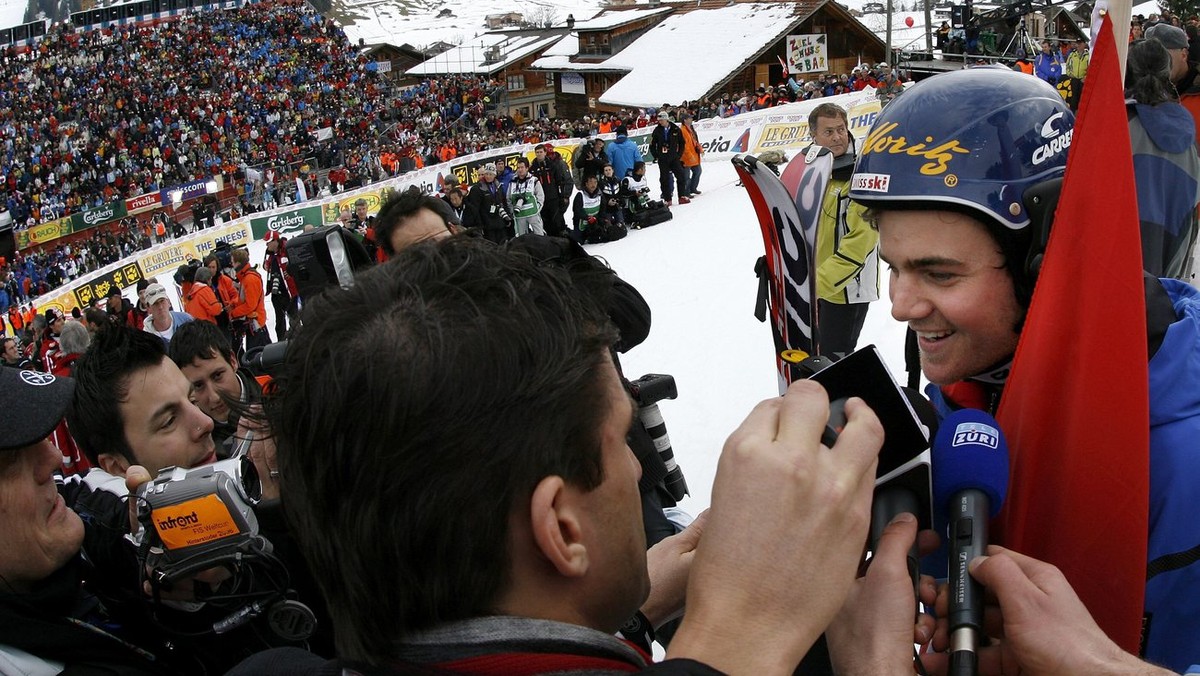 Swiss ski racer Marc Berthod, right, is interviewed by media people as the winner of the race in the finish area of today's men's ski world cup slalom in Adelboden, Switzerland, Sunday, Janu ...