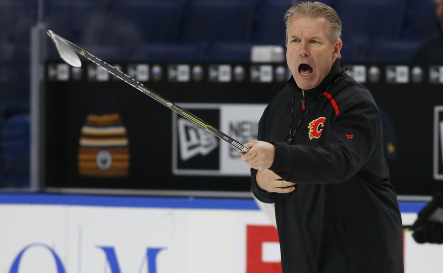 Calgary Flames associate coach Geoff Ward gives instruction during an NHL hockey practice Tuesday, Nov. 26, 2019, in Buffalo, N.Y. Flames general manager Brad Treliving says coach Bill Peters remains  ...