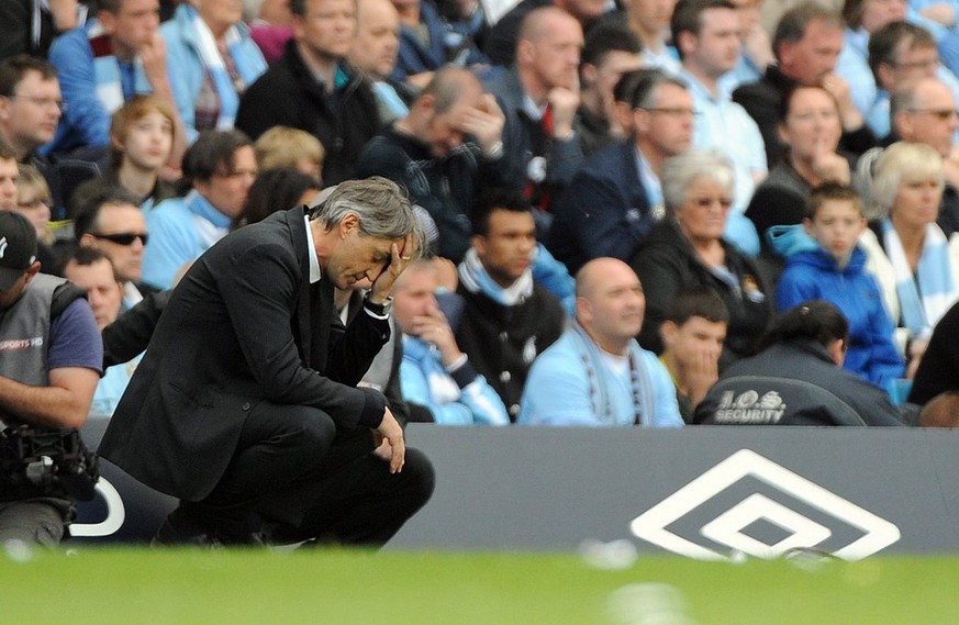 epa03217917 Manchester City manager Roberto Mancini reacts during the English Premier League soccer match at Etihad Stadium Manchester, Britain, 13 May 2012. DataCo terms and conditions apply. http//w ...