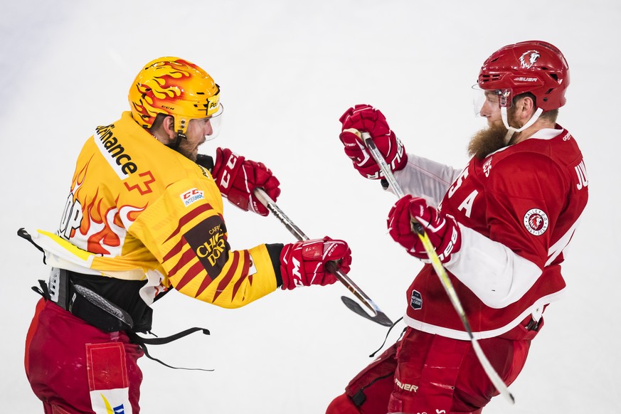 Le top scorer de Langnau Christopher DiDomenico, gauche, lutte avec le defenseur lausannois Jonas Junlan, droite, lors du septieme match du quart de finale de play off du championnat suisse de hockey  ...