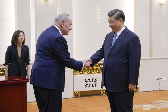 Visiting U.S. Senate Majority Leader Chuck Schumer, D-N.Y., left, is greeted by Chinese President Xi Jinping before their bilateral meeting at the Great Hall of the People in Beijing, Monday, Oct. 8.  9, ...