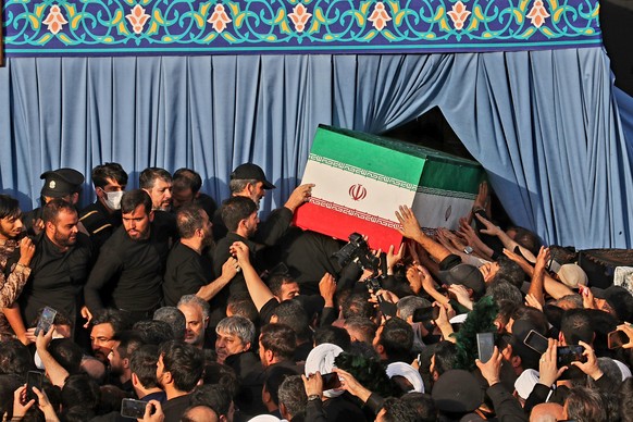 In this photo released by Iran's Supreme Leader's office, mourners carry the coffin of the late Iranian Supreme Leader Ayatollah Ali Khamenei during funeral prayers held as part of the daysl ...