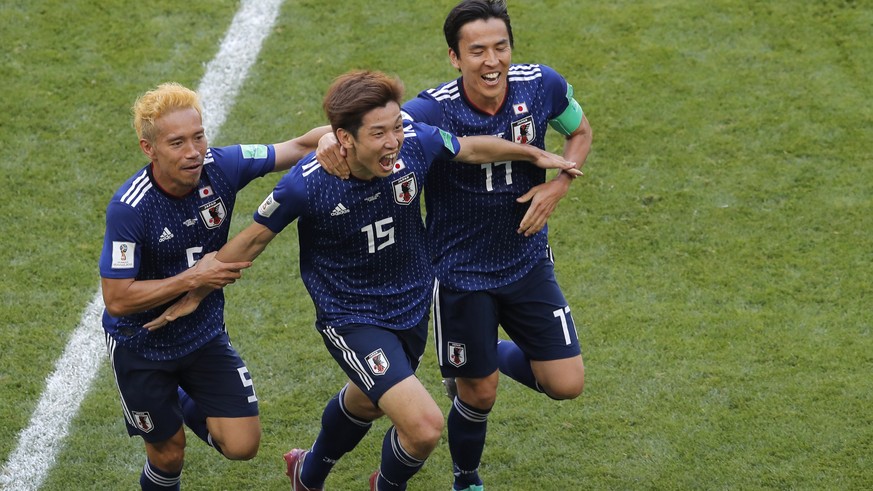 Japan&#039;s Yuya Osako, centre, celebrates after scoring his side&#039;s 2nd goal with teammates Makoto Hasebe, right, and Yuto Nagatomo, left, during the group H match between Colombia and Japan at  ...