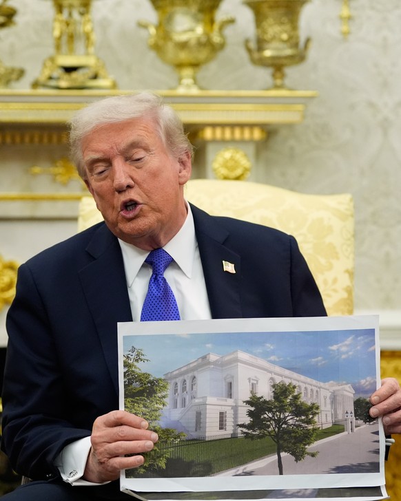 President Donald Trump holds an artist rendering of the new White House ballroom while meeting with NATO Secretary General Mark Rutte in the Oval Office of the White House in Washington, Wednesday, Oc ...