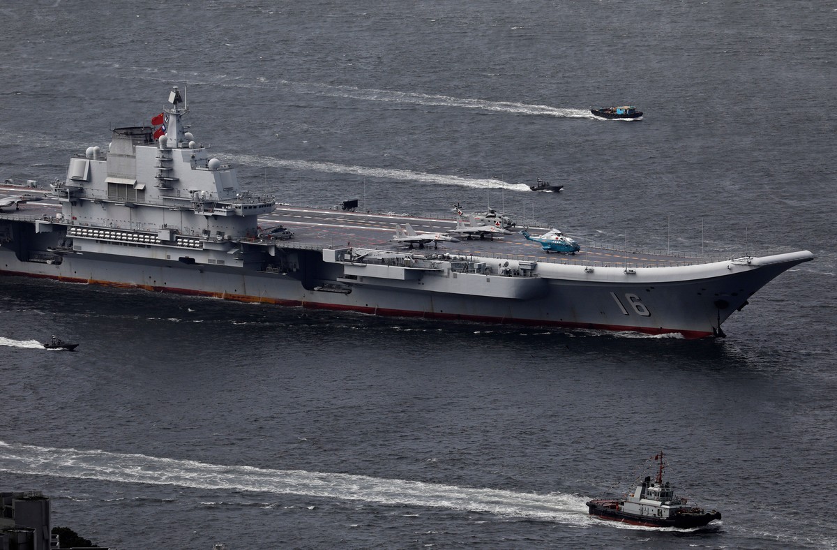 FILE -The Liaoning, China's first aircraft carrier, sails into Hong Kong for a port call to celebrate the 20th anniversary of the People's Liberation Army (PLA) garrison's presence in t ...