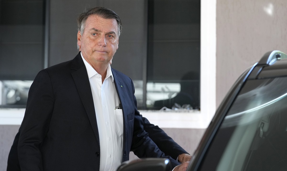 Former Brazilian President Jair Bolsonaro enters a car after speaking to the press outside his home after Federal Police agents carried out a search and seizure warrant in Brasilia, Brazil, Wednesday, ...