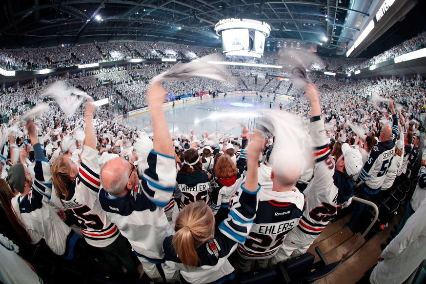 Winnipeg Jets fans cheer on the team as players hit the ice before Game 1 in an NHL hockey first-round playoff series against the Minnesota Wild, Wednesday, April 11, 2018, in Winnipeg, Manitoba. (Joh ...